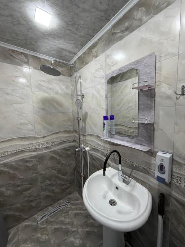 a bathroom with a sink and a mirror at BelGa Guest House in Gyumri
