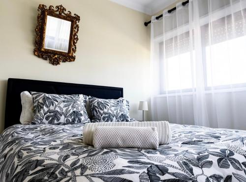 a bedroom with a large bed with a mirror on the wall at Casa de férias in Monte