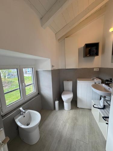 a bathroom with a toilet and a sink at Appartamento San Rocco in Intra