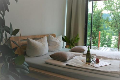 a bedroom with a bed with pillows and a window at Danuvius18 in Obernzell