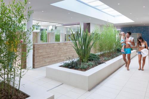 a rendering of a lobby with people walking in a building at Villaggio Turistico Internazionale in Bibione