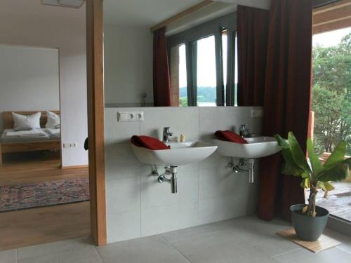 a bathroom with two sinks and a mirror at Danuvius18 in Obernzell