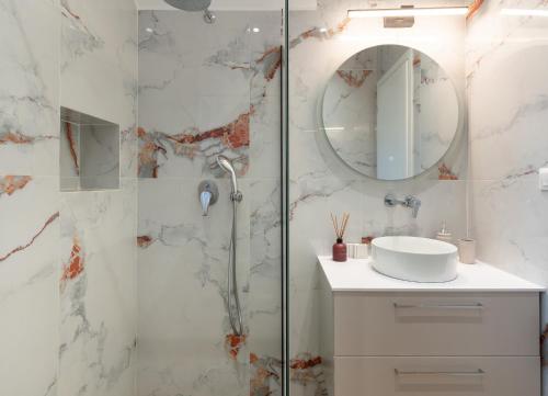 a bathroom with a shower with a sink and a mirror at Casa Elaia in Pylos