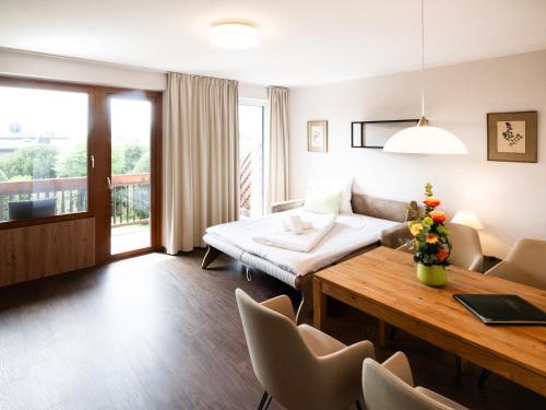 a hotel room with a bed and a table and chairs at Hotel Haus Arenberg in Salzburg