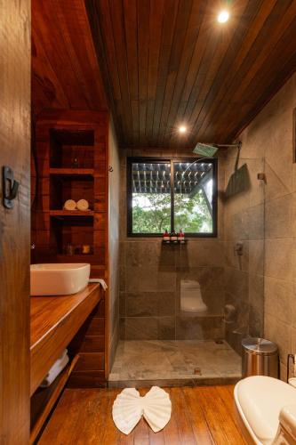 a bathroom with a tub and a sink and a shower at Naturave Monteverde - Treetop Cabins in Monteverde Costa Rica