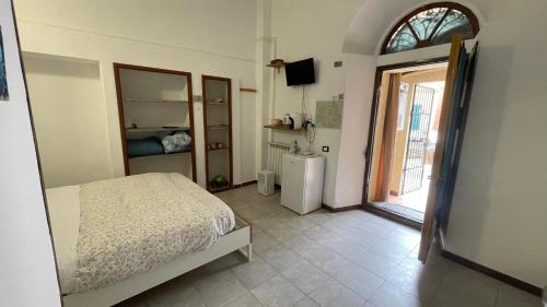 a bedroom with a bed and a room with a window at Affittacamere l'Acciuga in La Spezia