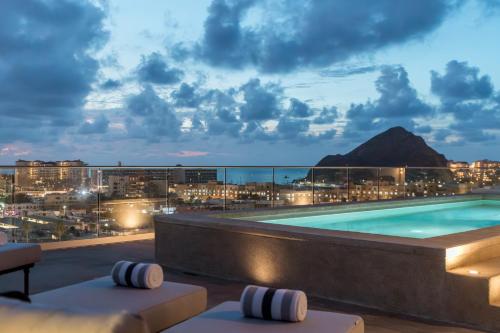 a pool on the roof of a hotel at night at Double Suite Luxury Retreat 605 Tower in Cabo San Lucas