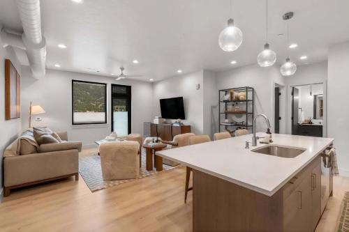 a kitchen and living room with a sink and a couch at Refined Big Sky Luxury Condo in Big Sky