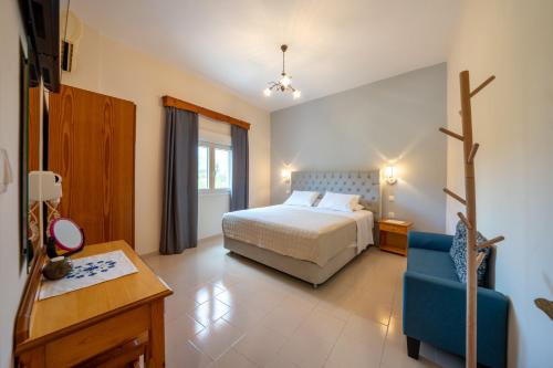 a bedroom with a bed and a blue chair at Red Dragon Exclusive accommodation in Dassia