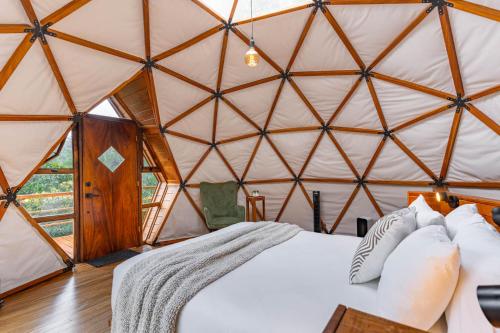 a bedroom with a bed in a yurt at Naturave Monteverde - Treetop Cabins in Monteverde Costa Rica