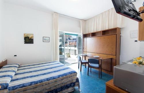 a hotel room with a bed and a desk at Casavacanze Internazionale in Diano Marina