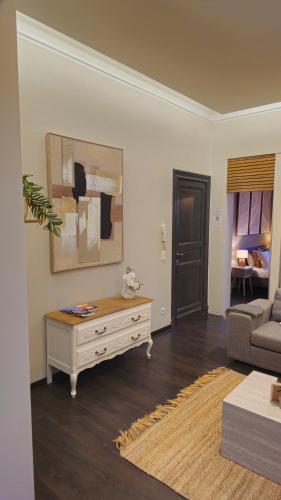 a living room with a couch and a table at LA SUITE 159 in Namur