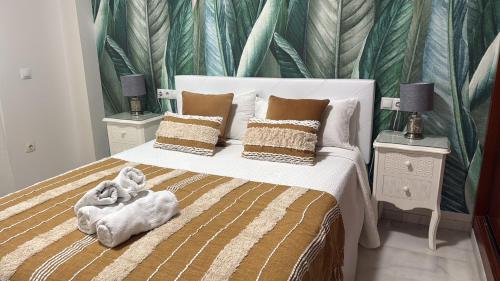a bedroom with a large bed with two night stands at AljaLux Sevilla Bormujos in Bormujos