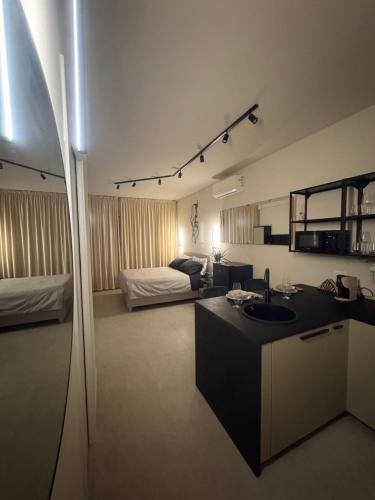 a living room with a sink and a bedroom at Marilux oasi di relax in Marina di Carrara