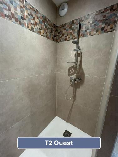 a bathroom with a shower with a quest sign at L'Arc en Ciel in Gréoux-les-Bains
