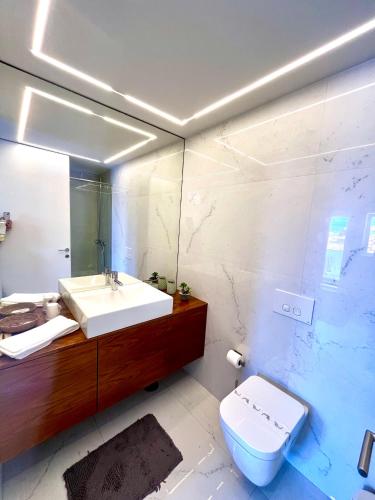 a bathroom with a sink and a toilet at Loft City Center Viana in Viana do Castelo