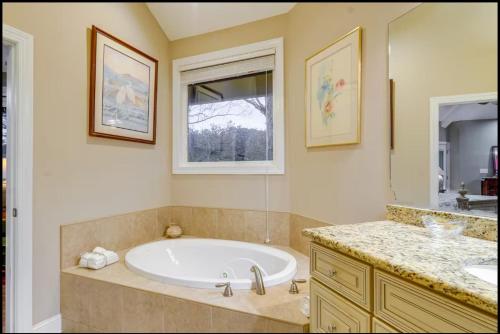 a large bathroom with a tub and a sink at Spacious Lakefront in Fayetteville