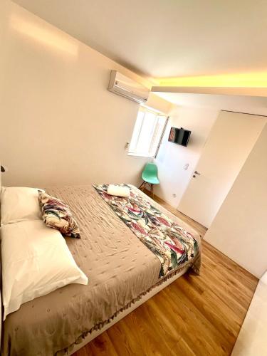 a bedroom with a bed in a room with a window at Loft City Center Viana in Viana do Castelo