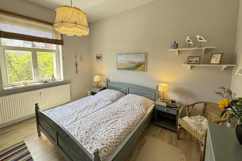a bedroom with a bed and two windows at Ferienwohnung Truding in Stralsund