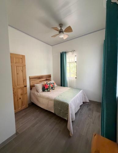a bedroom with a bed with flowers on it at Serenity House in Cahuita