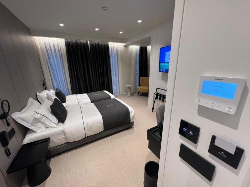 a hotel room with a bed and a television at Centrale Hotel in Tirana