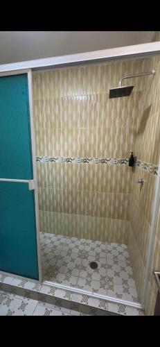 a bathroom with a shower with a tiled floor at Lohana's House Beach in Cartagena de Indias