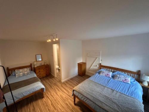 a bedroom with two beds in a room at Gites Le Chezeau in Saint-Amand-Magnazeix