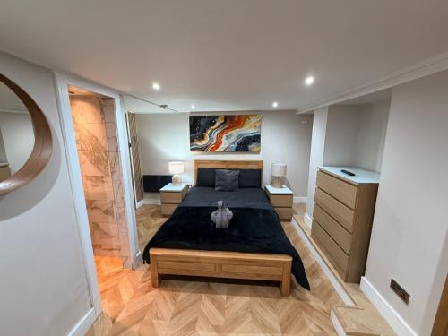 a bedroom with a bed with a stuffed animal on it at Hendham Rooms - Near Etihad Stadium, CoOp Live Arena, National Cycling Centre & 24 Hour Asda in Manchester