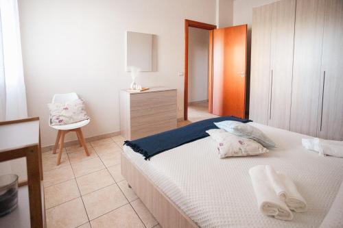 a bedroom with a bed and a chair in it at Mediterranea Modica - Seaside Home in Marina di Modica