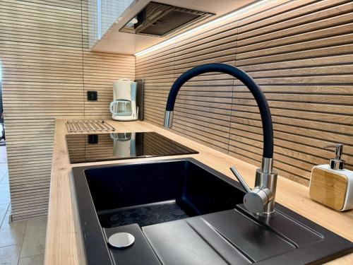 a kitchen with a sink and a faucet at Leśny Reset in Imielnia