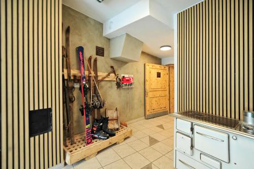 a kitchen with skis on the wall and a wall at Hotel Traube in Fliess