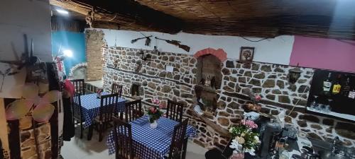 a room with two tables and a brick wall at Rosa B&B in Lin