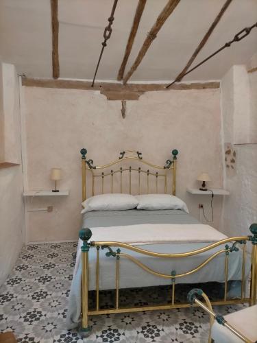 a bedroom with a bed with a metal frame at Casona Los Infantes in Villanueva de los Infantes