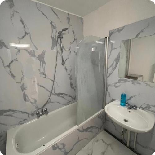 a bathroom with a sink and a bath tub and a toilet and a sink at Grace Family Home 2 in Brussels