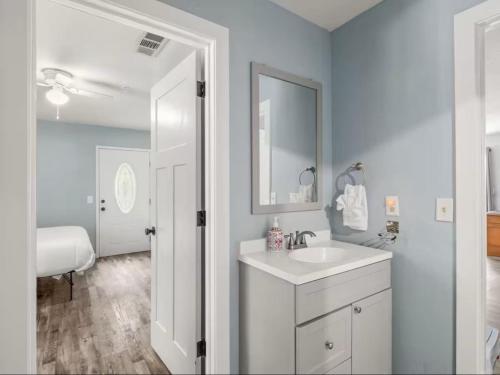 a white bathroom with a sink and a mirror at Meadowlark Retreat in Ahwahnee