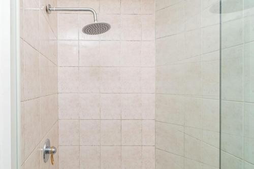 a bathroom with a shower with a glass door at 3 bed ground in sandton in Johannesburg