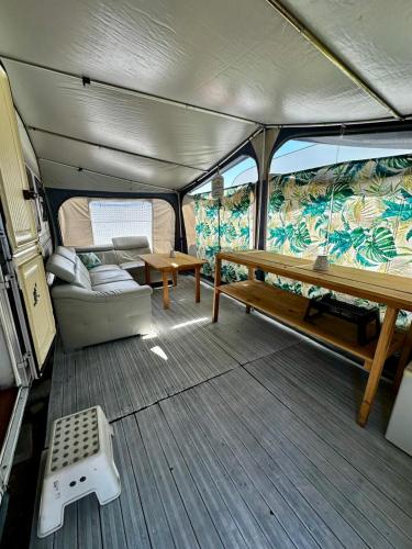 a view of the inside of a boat with a table and bench at Przyczepa Wendy in Jastarnia