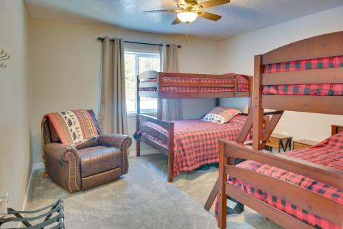 a bedroom with two bunk beds and a chair at Kenai River Base! Spacious 2-Unit Cabin Compound in Soldotna