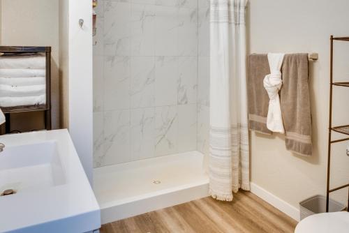 a bathroom with a shower and a sink at Kenai River Base! Spacious 2-Unit Cabin Compound in Soldotna