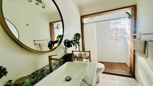 a bathroom with a tub and a mirror at House 78 in Coquimbo
