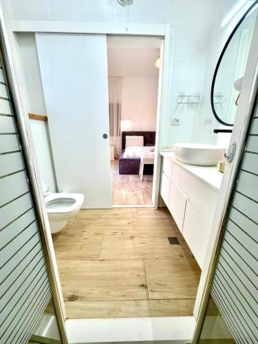 a bathroom with a toilet and a sink at Villa Casa Blanca in Kefar H̱ananya