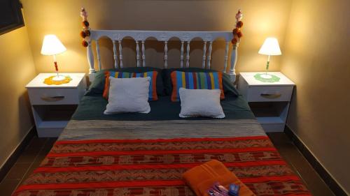 a bedroom with a bed with pillows and two night stands at La Chili in Salta