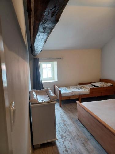 a room with a bed and a couch and a window at Chez Pépé in Limalonges