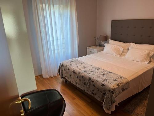 a bedroom with a large bed and a window at Pine Residence at Lav Meridien Resort in Podstrana