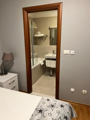 a bathroom with a bed and a tub and a sink at Pine Residence at Lav Meridien Resort in Podstrana