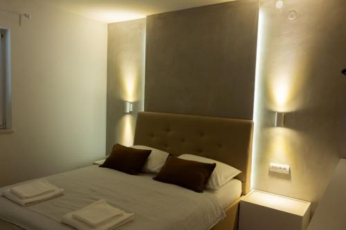 a bedroom with a bed with two towels on it at Apartment Solis 6 in Stara Novalja
