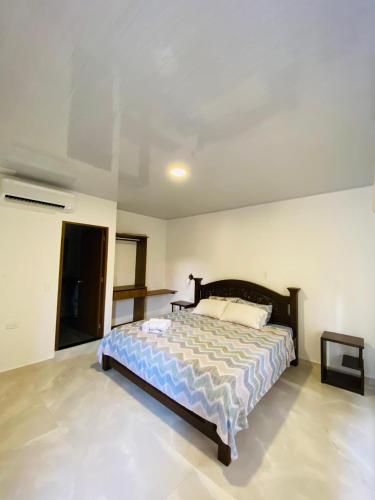a bedroom with a large bed in a room at Hotel Colonial Sol y Luna in Paz de Ariporo