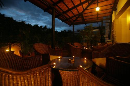 a table and chairs on a patio at night at juSTa Off MG Road in Bengaluru