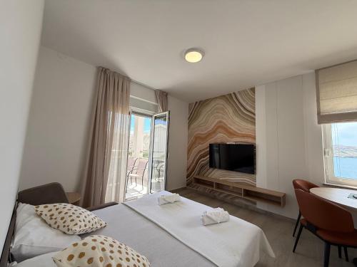 a hotel room with two beds and a television at Apartments by Resort Čulina in Metajna