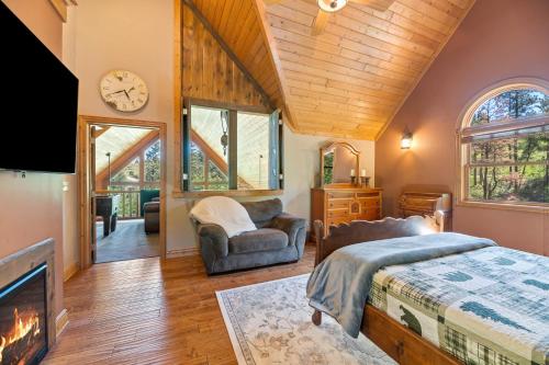 a bedroom with a bed and a tv and a fireplace at Destiny Luxury Log Cabin in Sturgis